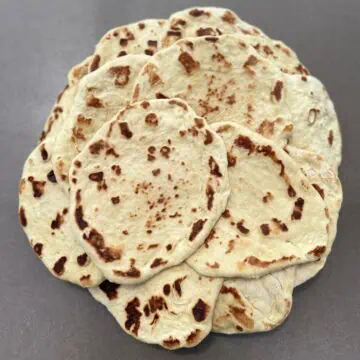 Soft homemade flatbread, perfect for wraps, dips, or as a side, cooked until golden brown