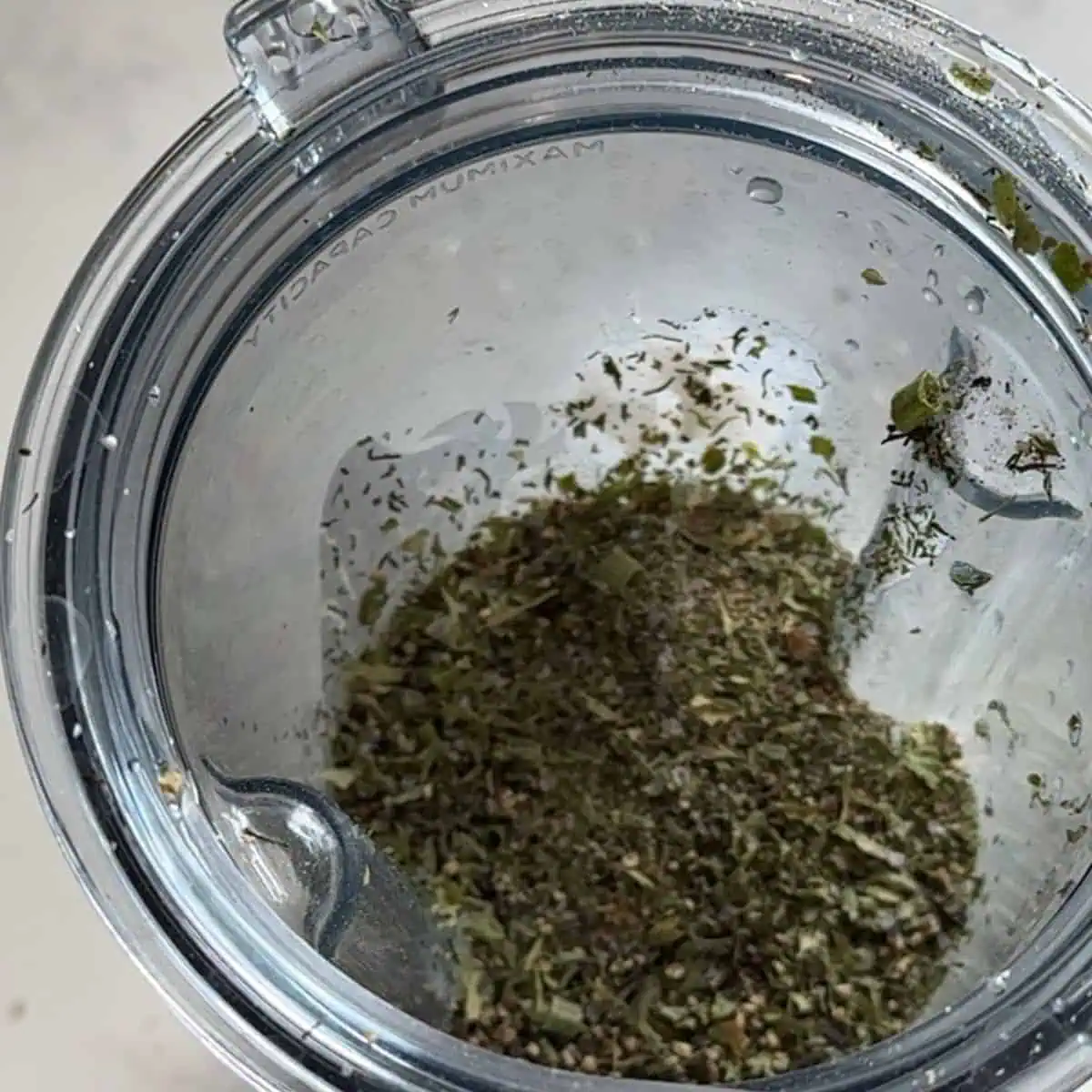 Mixing buttermilk ranch ingredients in a bowl with herbs, garlic, and lemon juice.