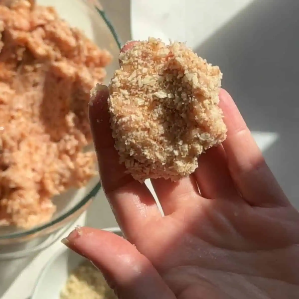 Chicken nugget dipped in breadcrumbs before baking. 