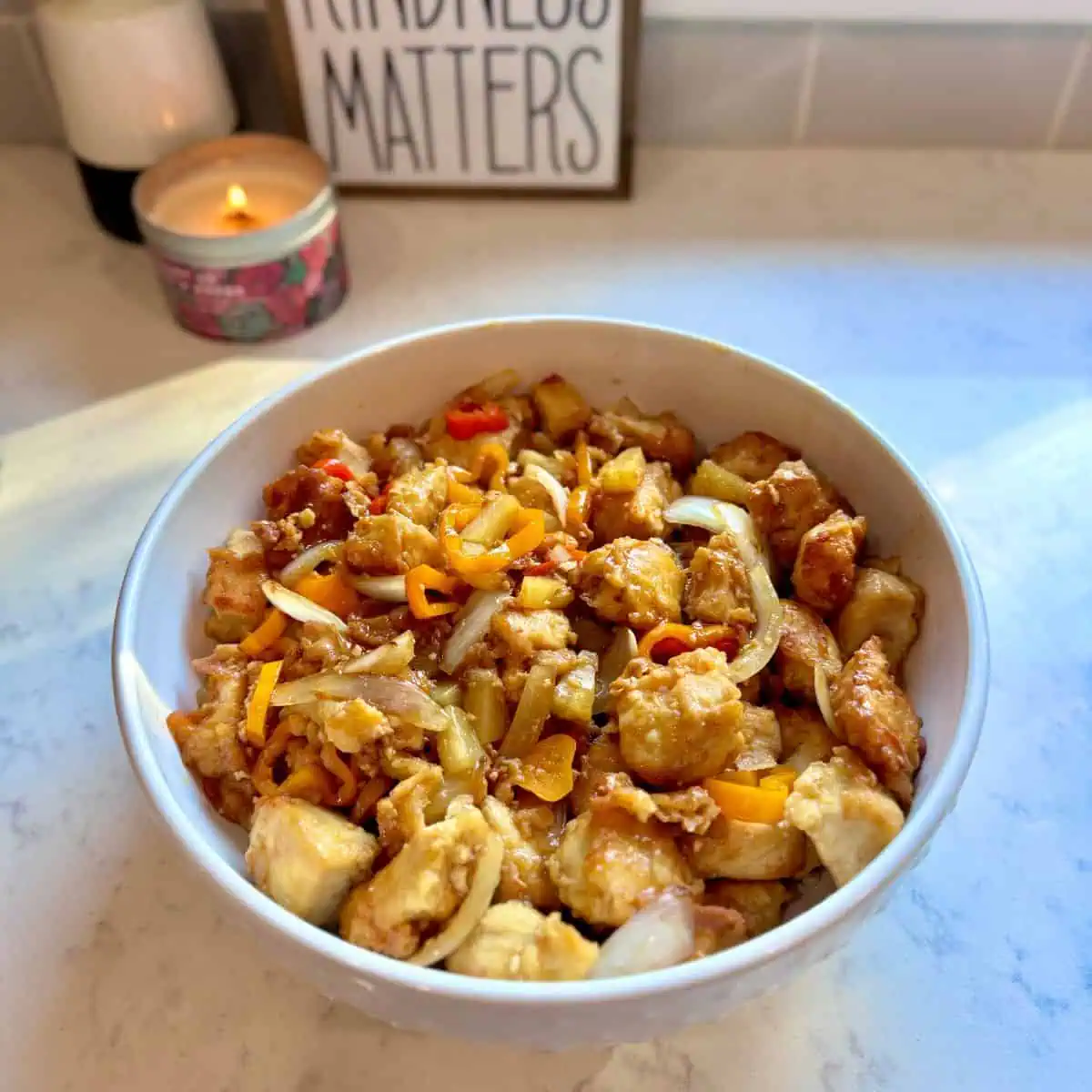 Angled shot of pineapple chicken with sweet peppers served over rice.  