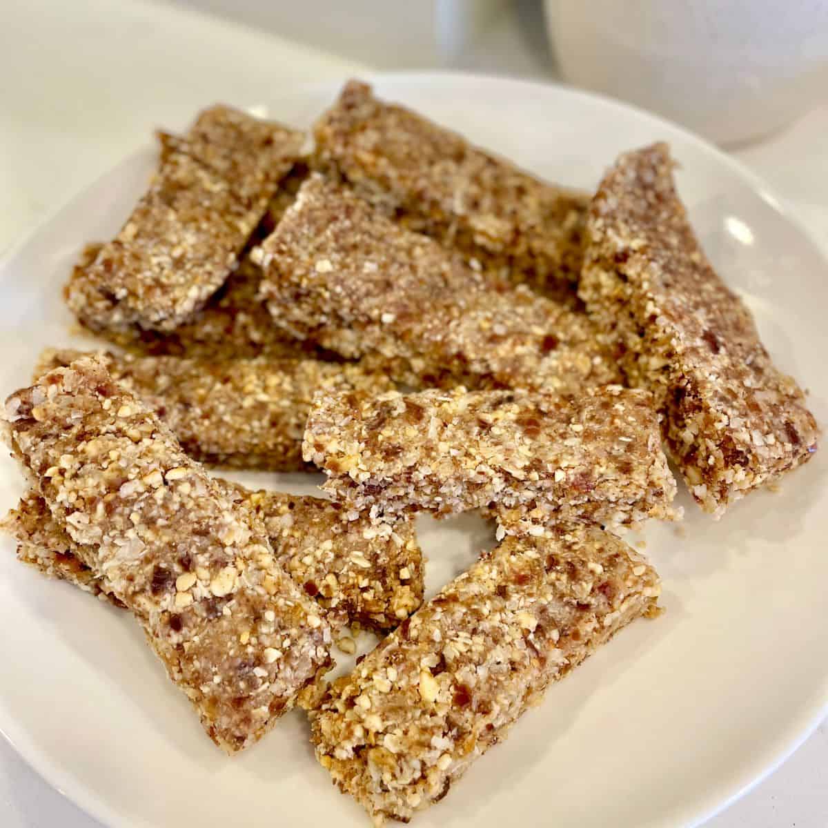 A close-up shot of a stack of freshly cut granola bars, highlighting their texture and ingredients.