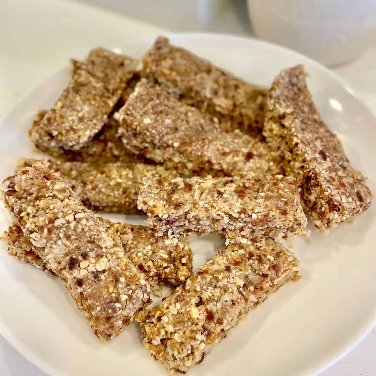 A close-up shot of a stack of freshly cut granola bars, highlighting their texture and ingredients.