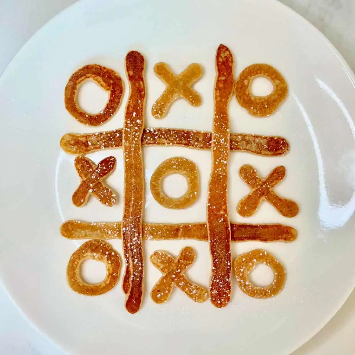 Fun tic-tac-toe pancakes served as a playful breakfast.