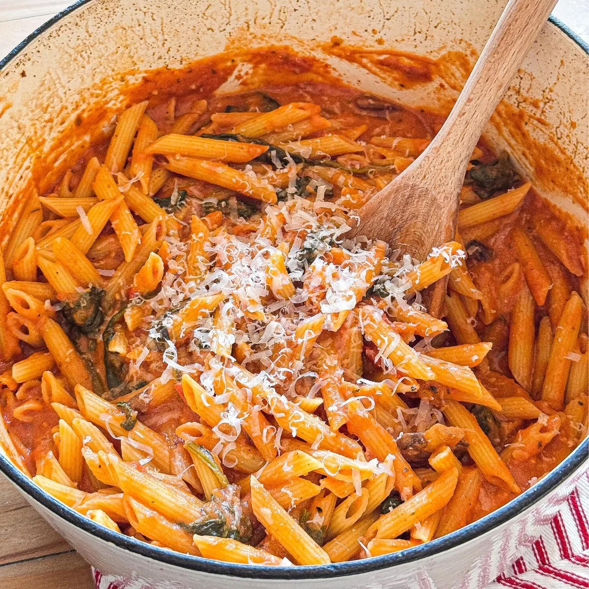 A beautifully plated bowl of Pasta Rosa garnished with fresh basil and Parmesan cheese