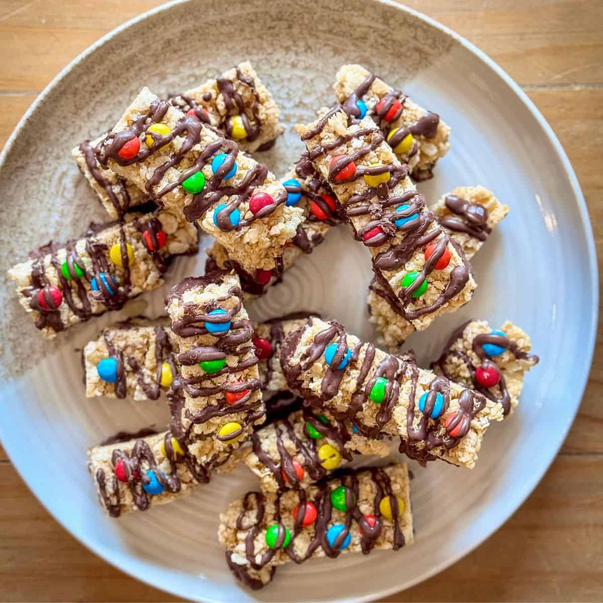 Chocolate-dipped granola bars with M&Ms on a plate
