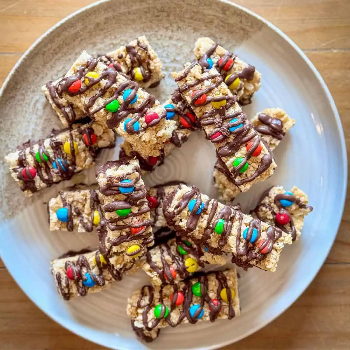 Chocolate-dipped granola bars with M&Ms on a plate