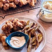 late of chicken nuggets and French fries with Chick-fil-A sauce and metal cooling rack in the background