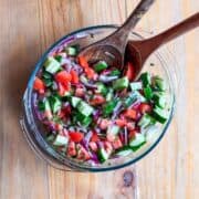 Top-down view of Mediterranean cucumber tomato salad in a serving bowl.