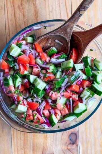 Top-down view of Mediterranean cucumber tomato salad in a serving bowl.