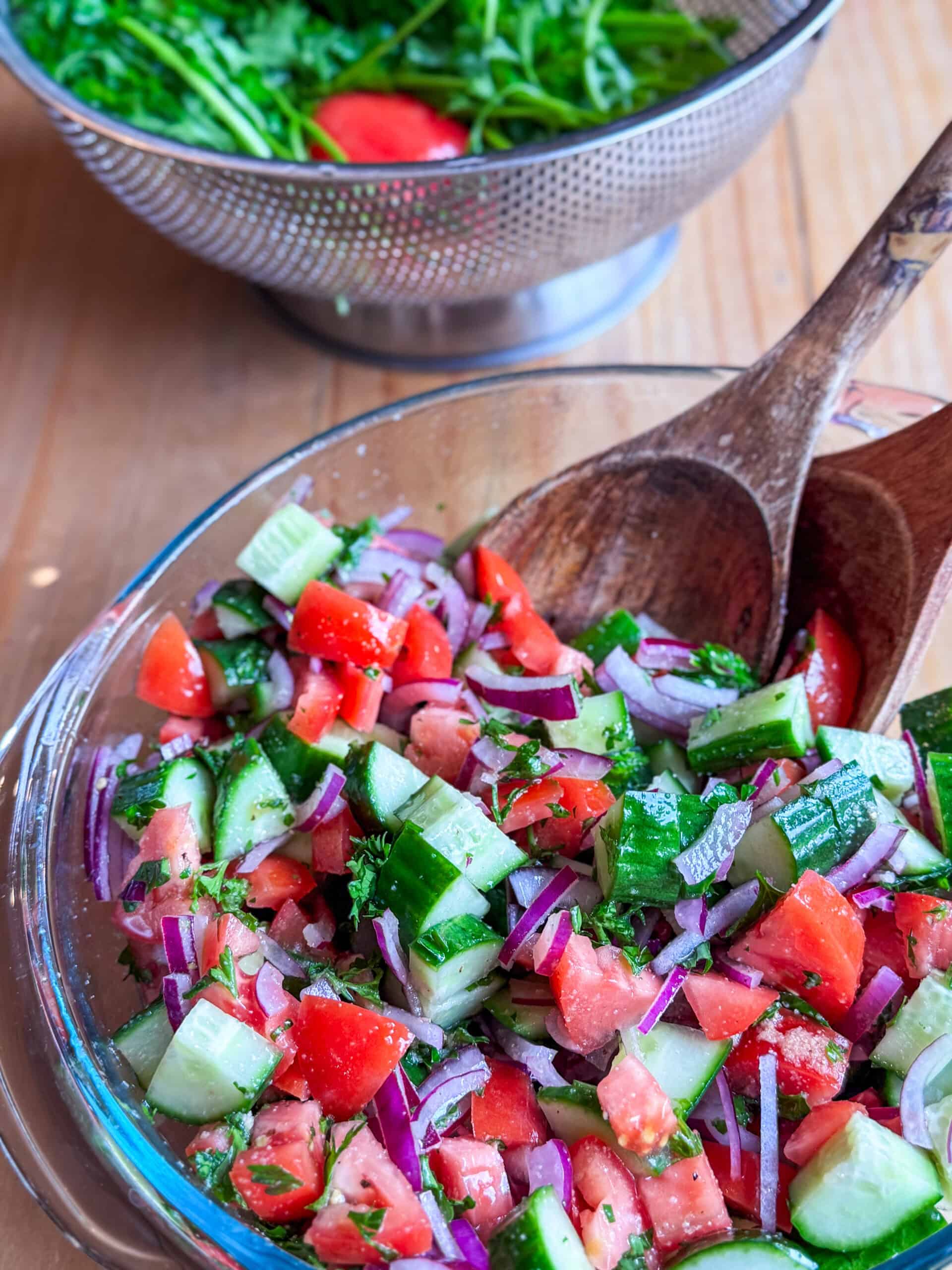 Finished Mediterranean cucumber tomato salad with cucumbers, tomatoes, red onion, and parsley.