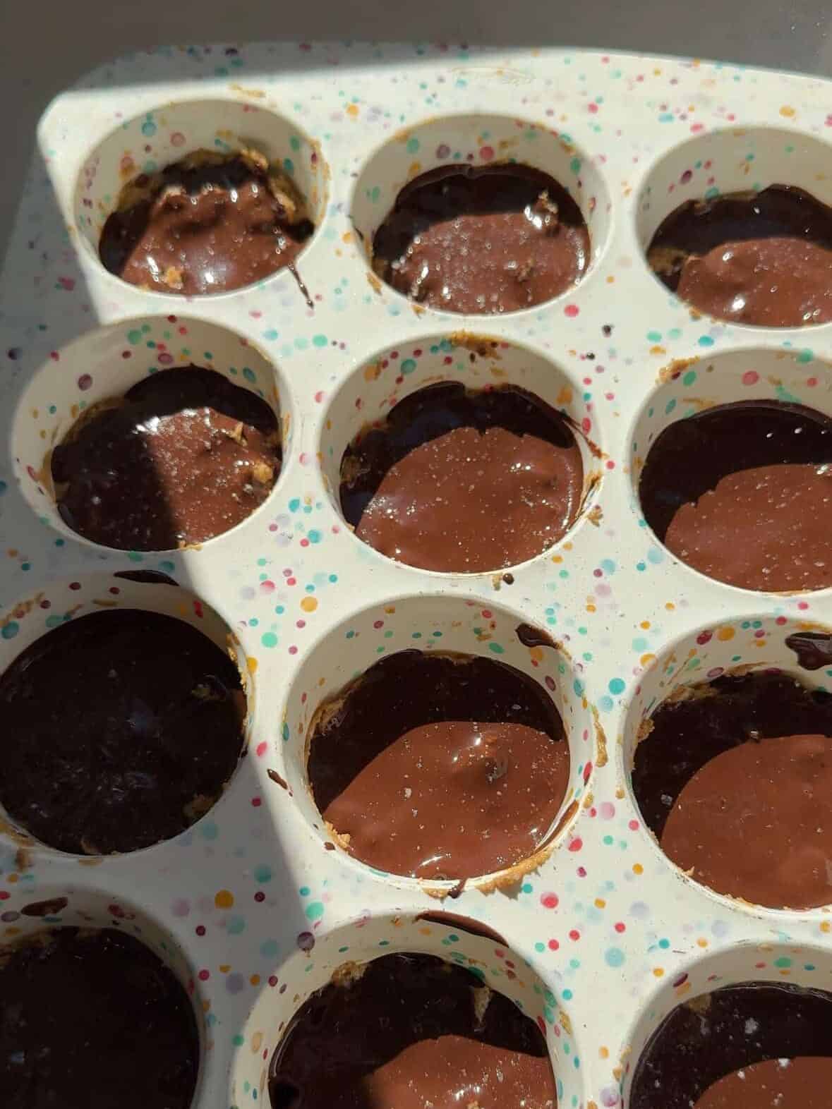 Protein peanut butter rice cake cups topped with sea salt flakes before freezing.