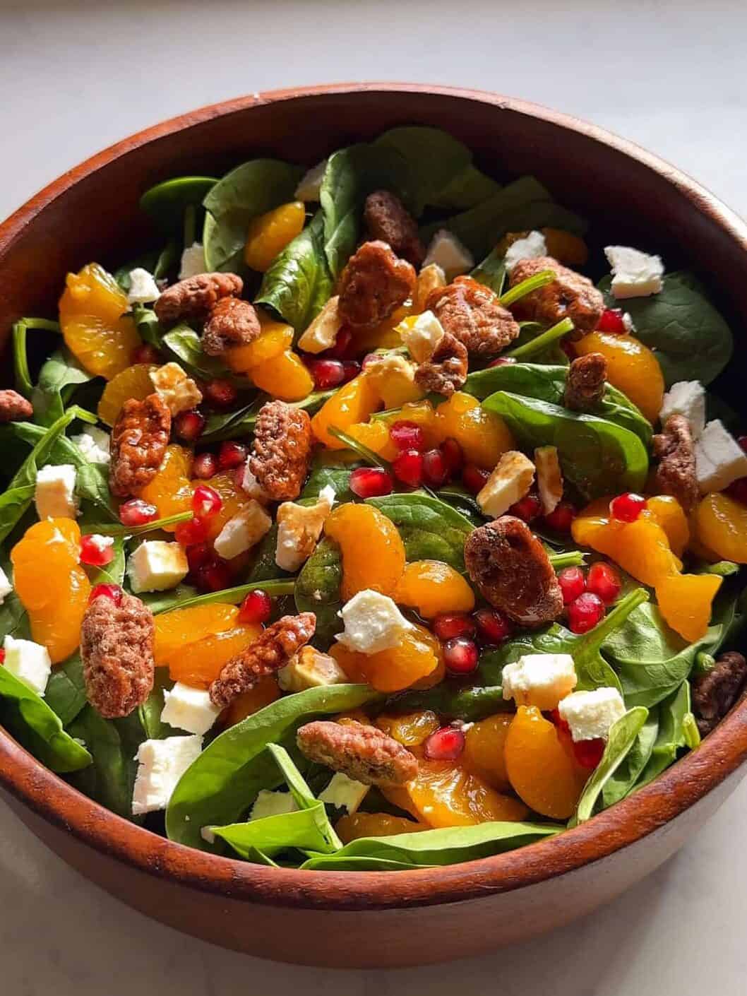 Fully assembled feta and pomegranate salad tossed with pomegranate molasses dressing.