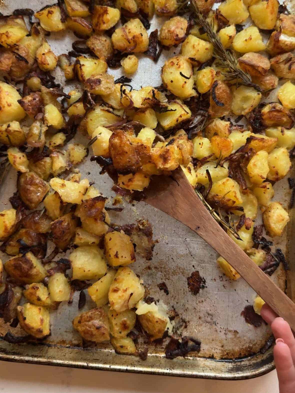 Crispy roasted yellow potatoes fresh from the oven on a sheet pan.