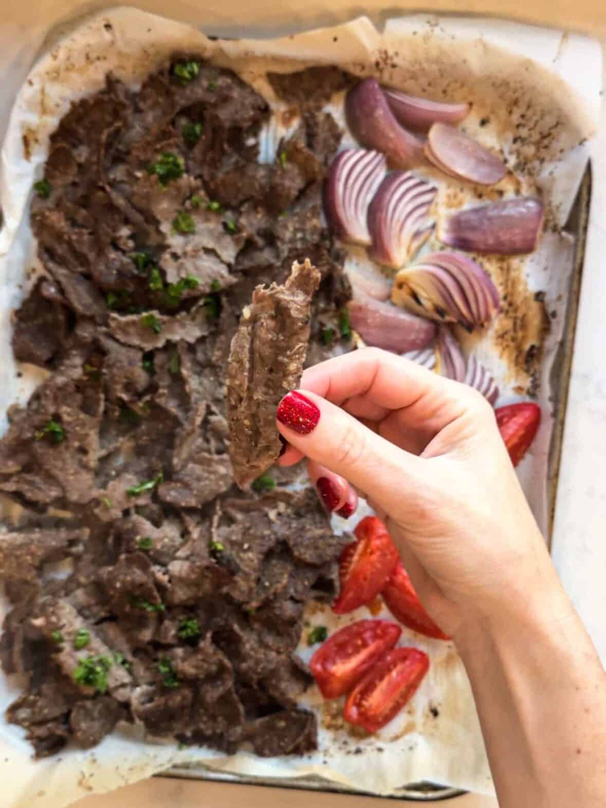 Broiled ground beef gyro meat with roasted tomatoes and onions after baking