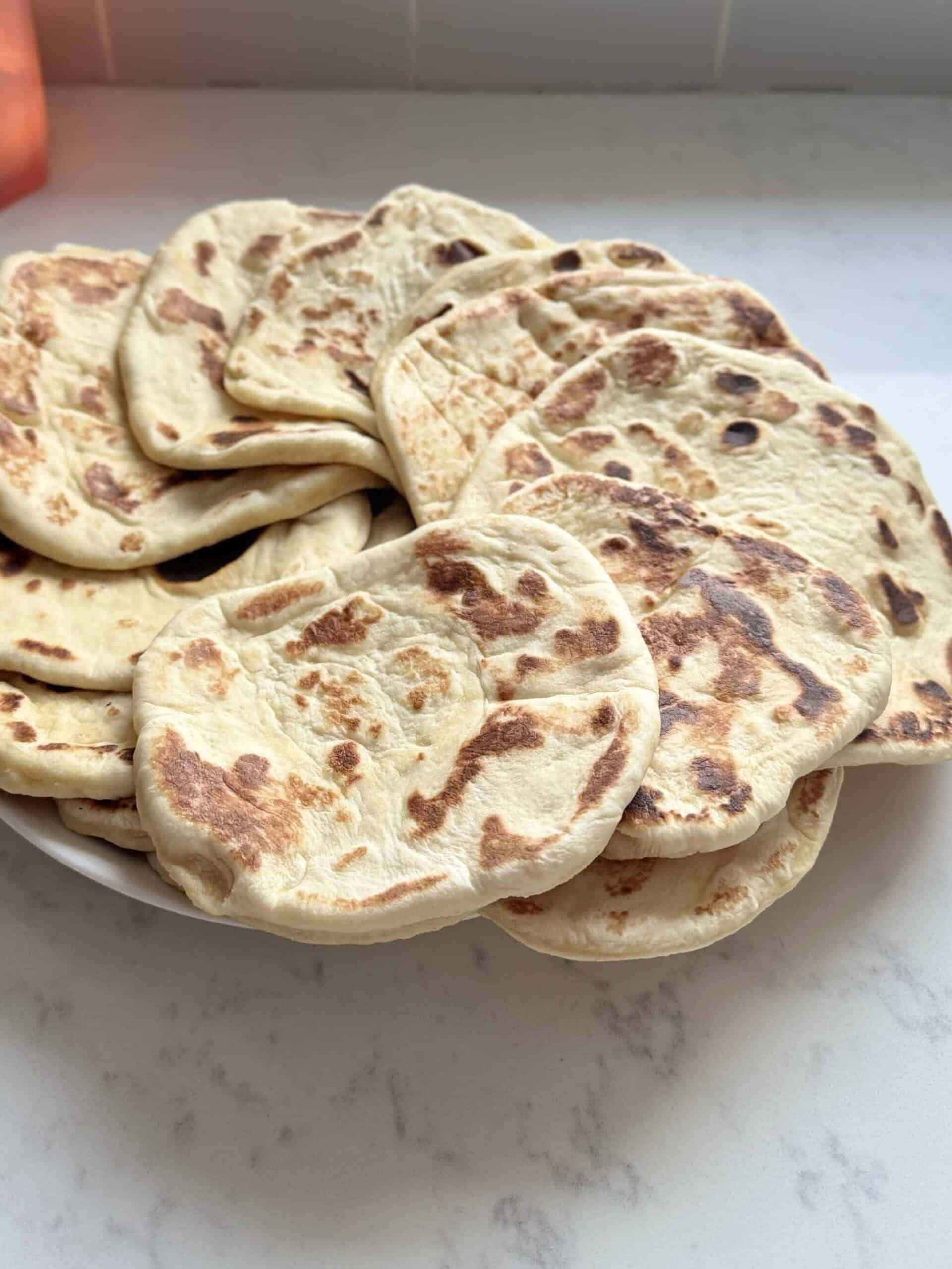 Close-up of soft homemade sweet flatbread on a plate, showing fluffy texture similar to Olga bread