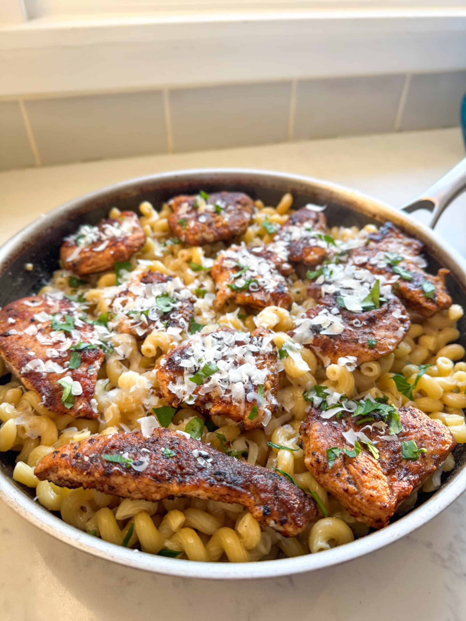 Close-up of creamy garlic parmesan chicken pasta with tender chicken, pasta, and freshly grated parmesan cheese