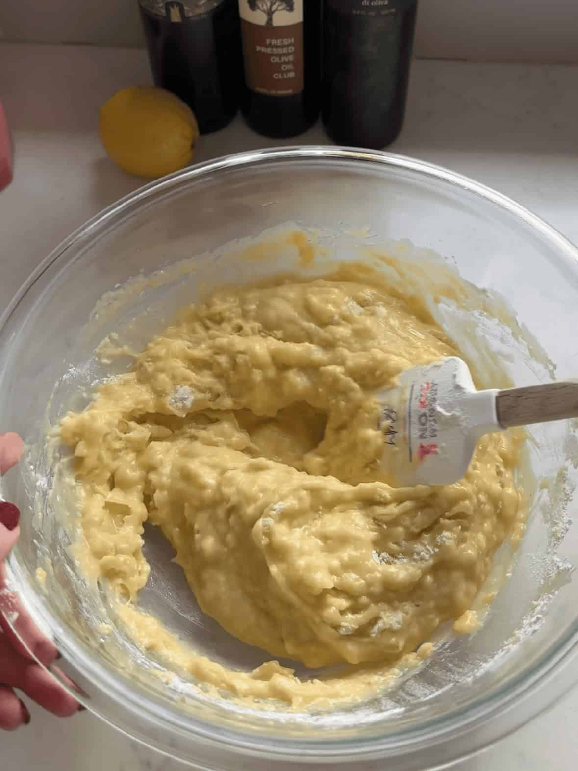Folding wet and dry ingredients together for olive oil Bundt cake