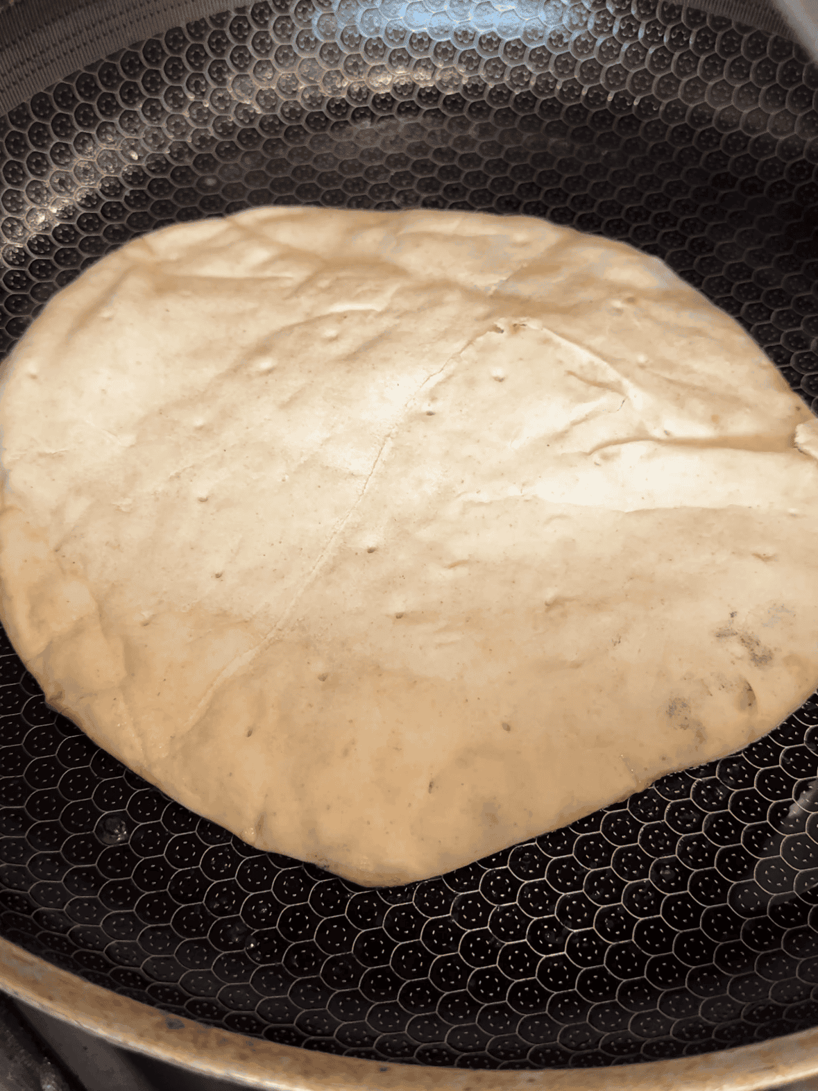 Cooking Greek smashed chicken tacos chicken-side down in a hot skillet