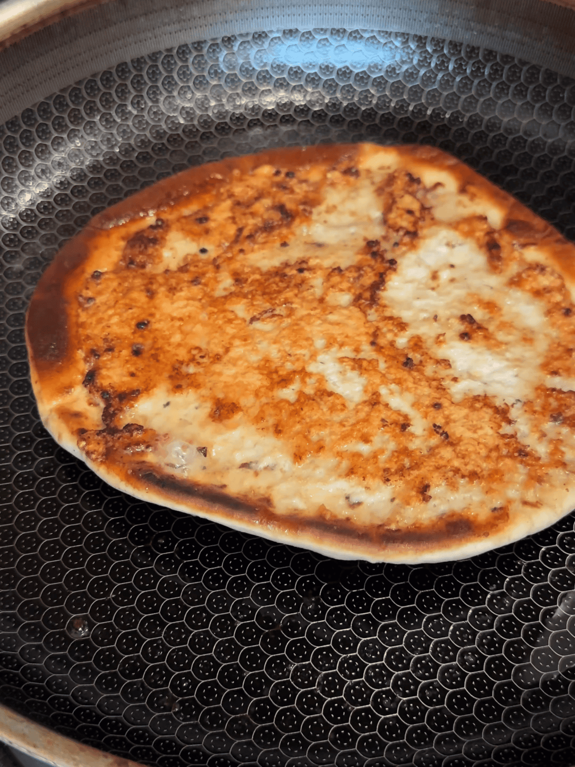 Flipping Greek smashed chicken taco to crisp the pita bread