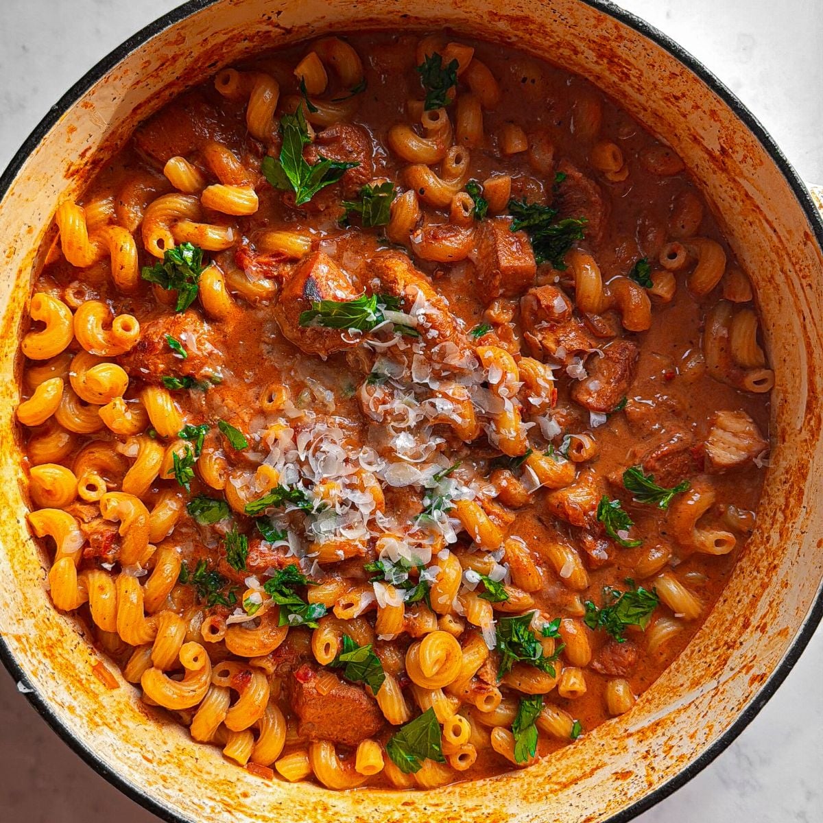 close up overhead creamy tomato chicken pasta showing creamy sauce and texture