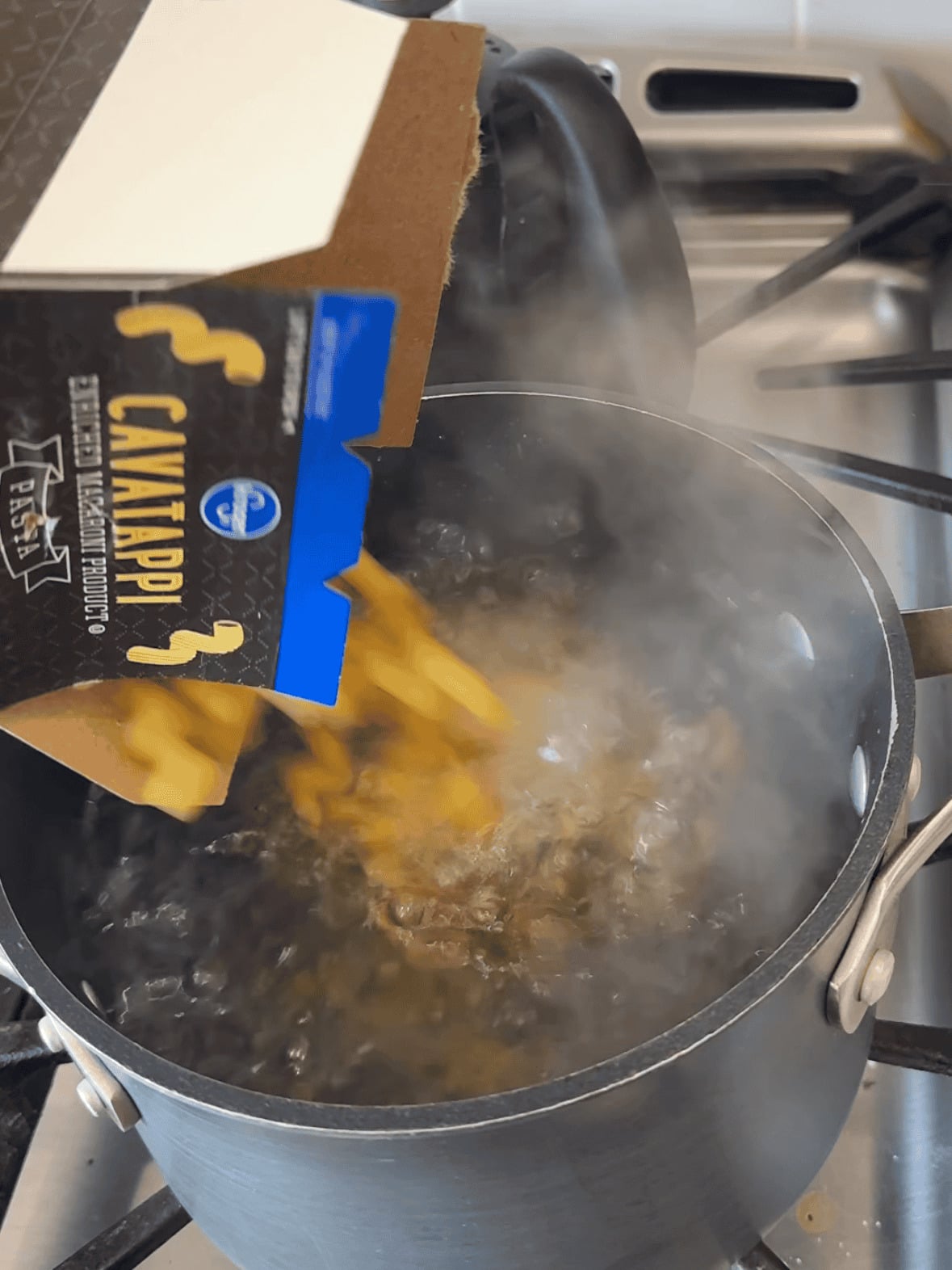 Step 1 cooking pasta in boiling water for creamy tomato chicken pasta recipe