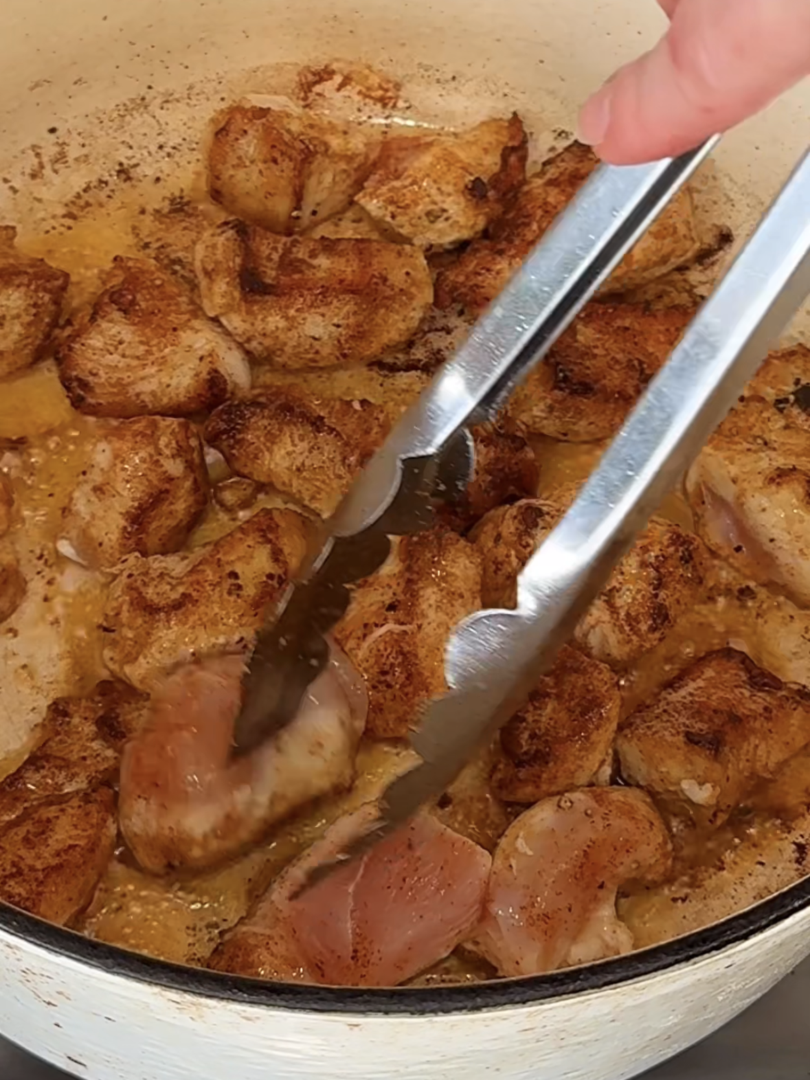 Step 2 searing seasoned chicken in pan for creamy tomato chicken pasta