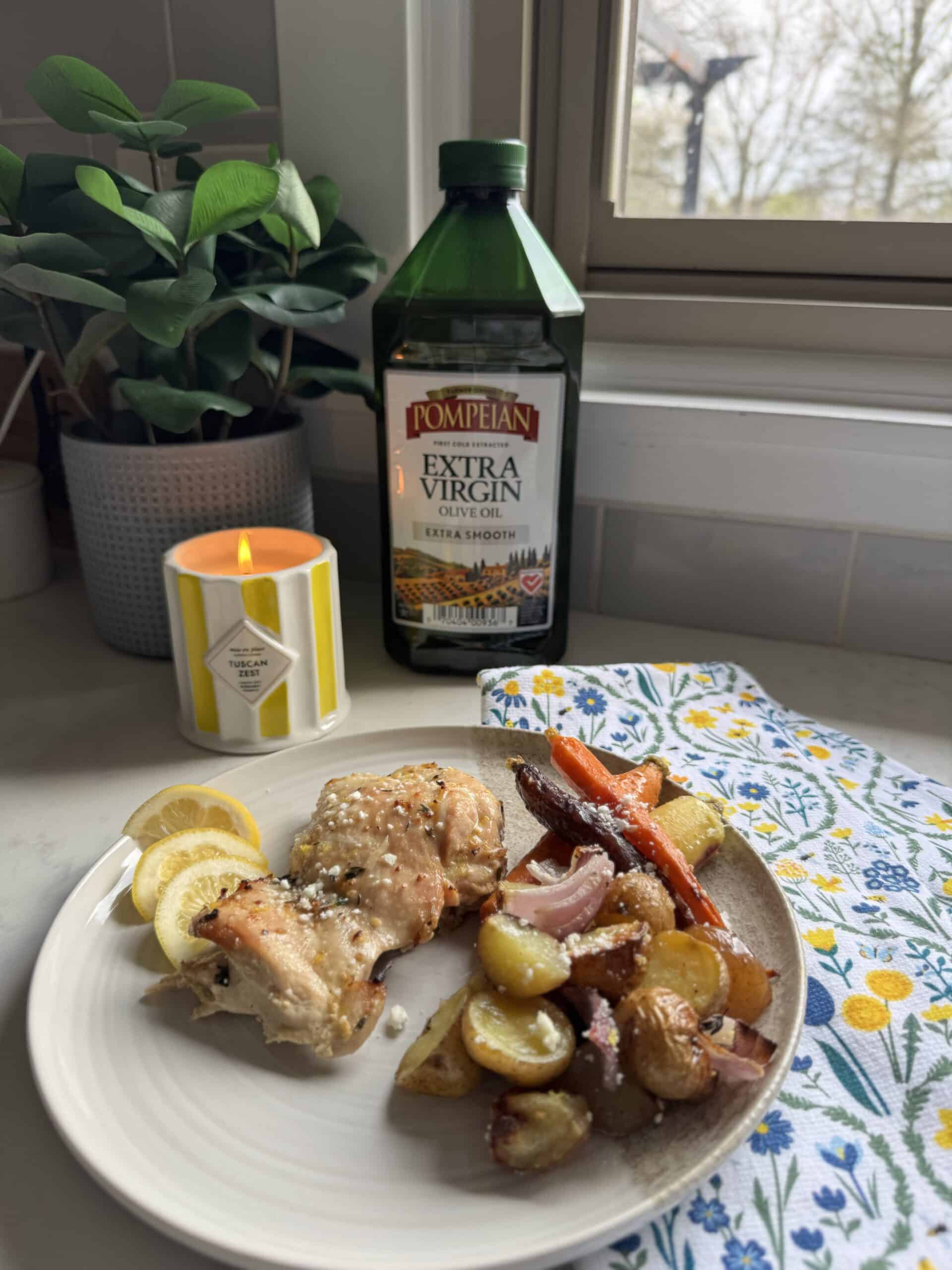 Plated one pan chicken thighs and veggies with roasted potatoes, carrots, red onion, lemon, and feta cheese