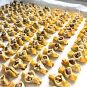Golden baked Armenian Manti dumplings on a tray made with wonton wrappers and seasoned ground sirloin.
