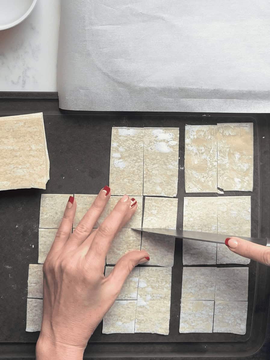 Wonton wrappers cut into small squares for making shortcut Armenian Manti dumplings.