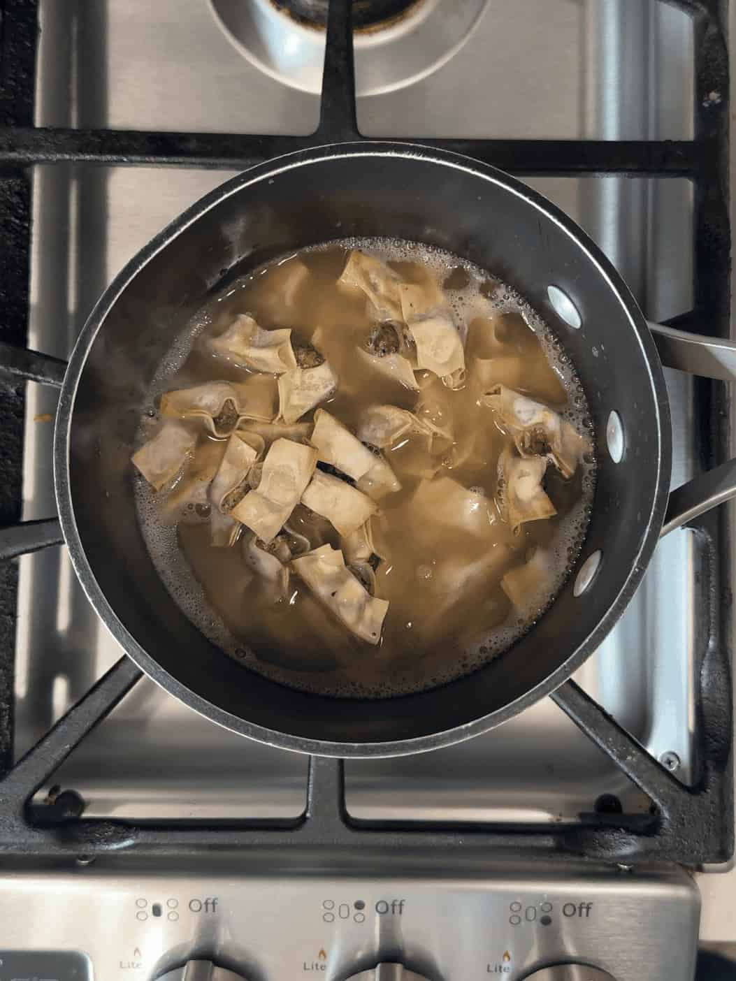 Armenian Manti simmering in chicken broth for two minutes before serving.