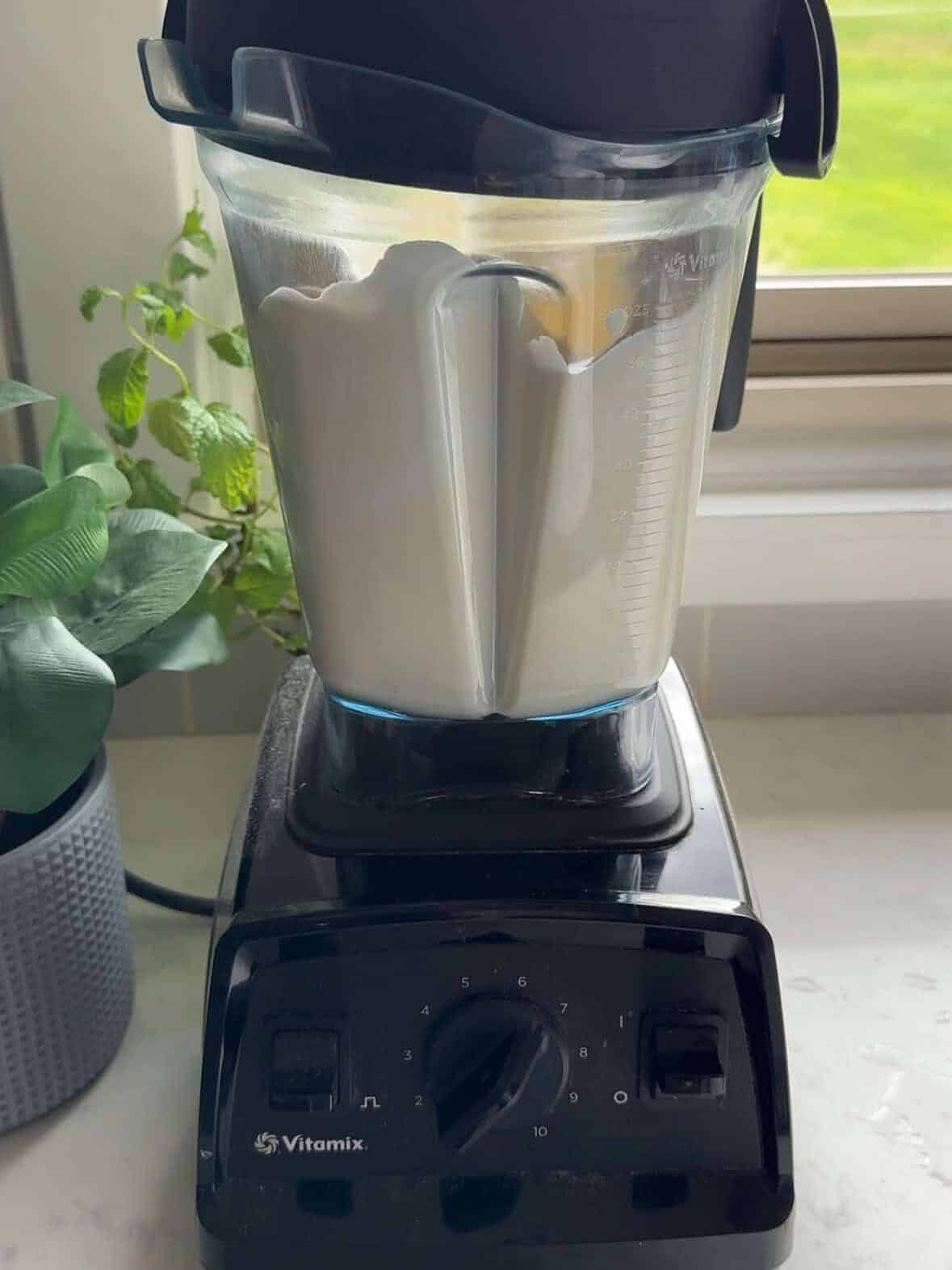 Plain yogurt and eggs being blended smooth in a blender before being added to the Armenian yogurt soup