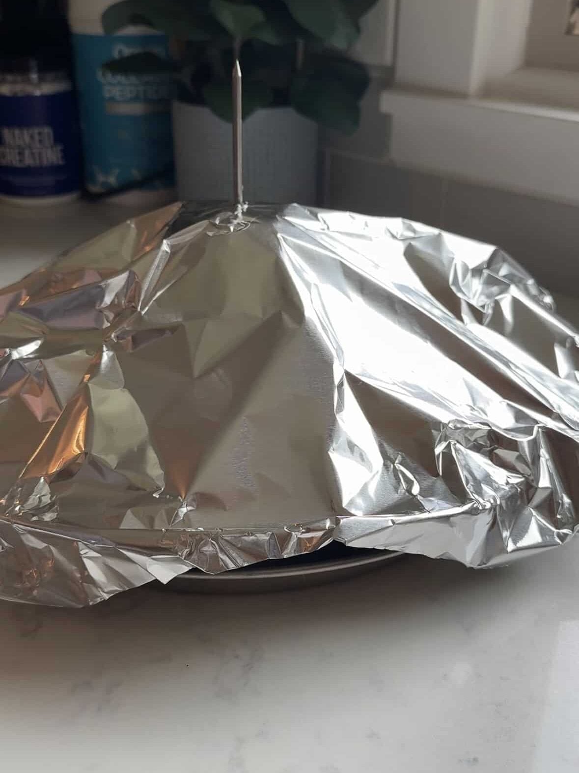 Vertical spit pan loosely covered with aluminum foil tent before going in the oven