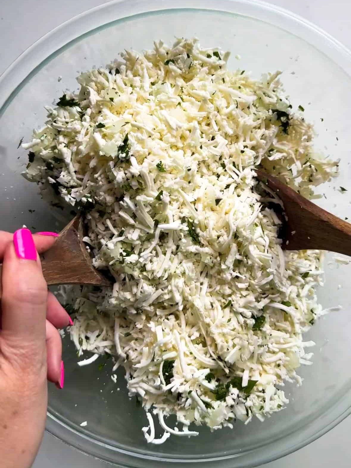 Shredded cheese and parsley mixed together for Armenian sheet cheese boreg filling