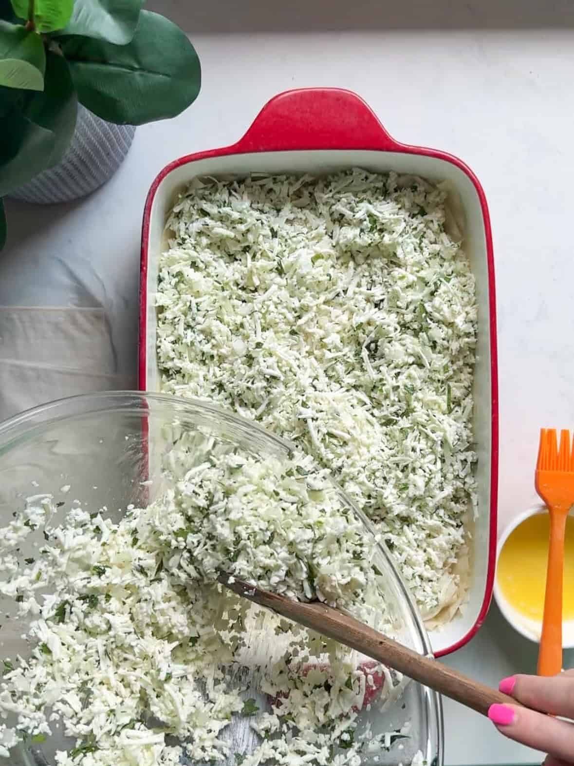 Spreading cheese filling over phyllo dough for Armenian sheet cheese boreg