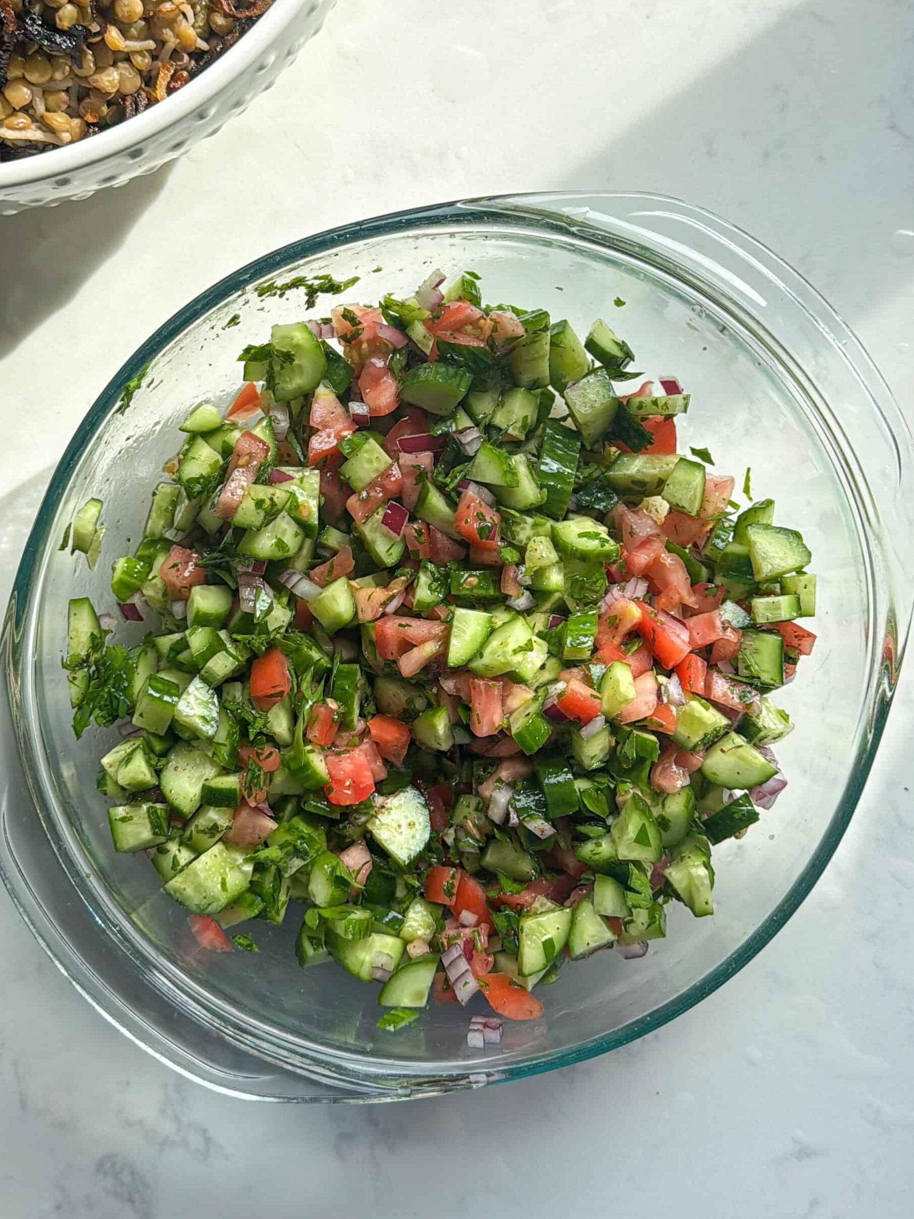 Fully mixed Mediterranean chopped salad with cucumber, tomato, and herbs