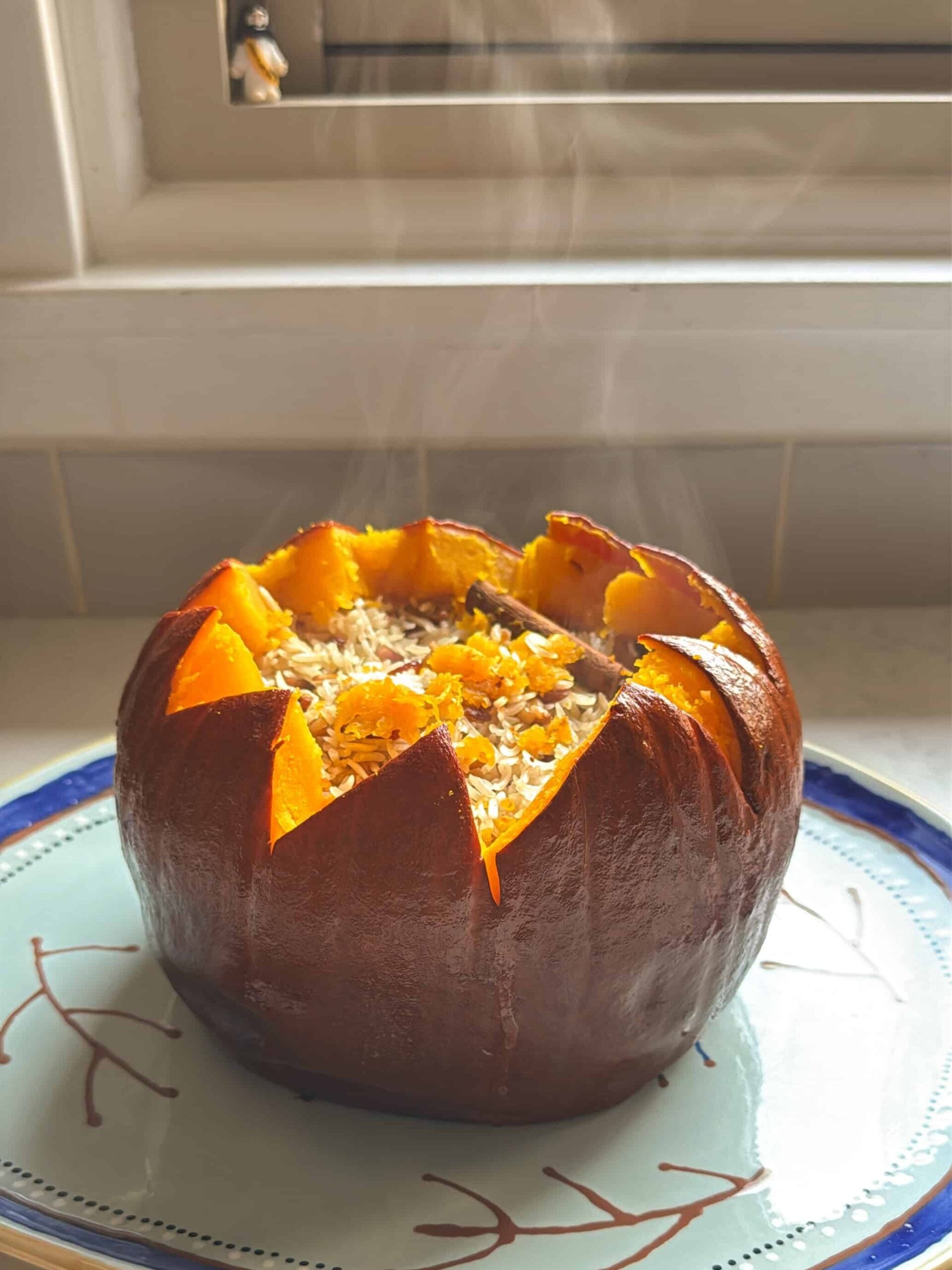 Steam rising from a freshly baked ghapama filled with rice and dried fruit