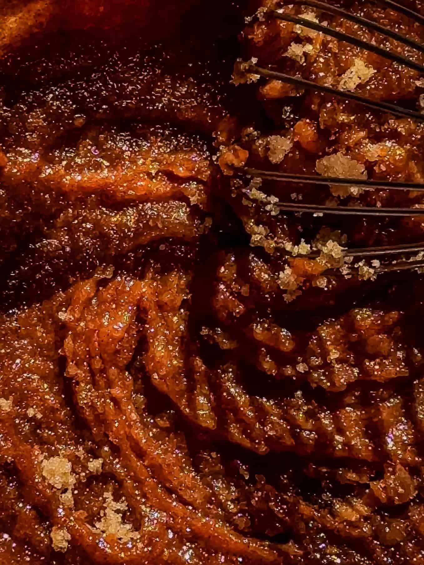 Whisking pumpkin purée, brown sugar, butter, and spices together for pumpkin cinnamon roll filling