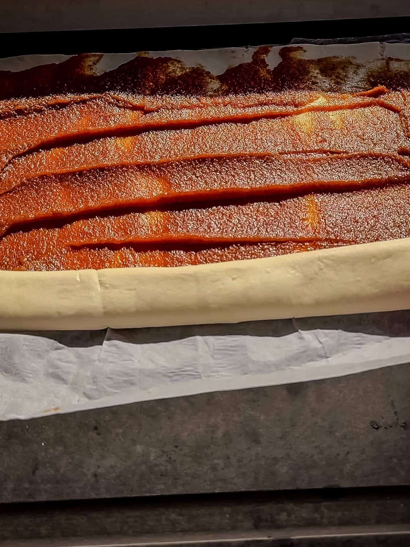 Pumpkin filling spread over puff pastry and rolled into a log for cinnamon rolls